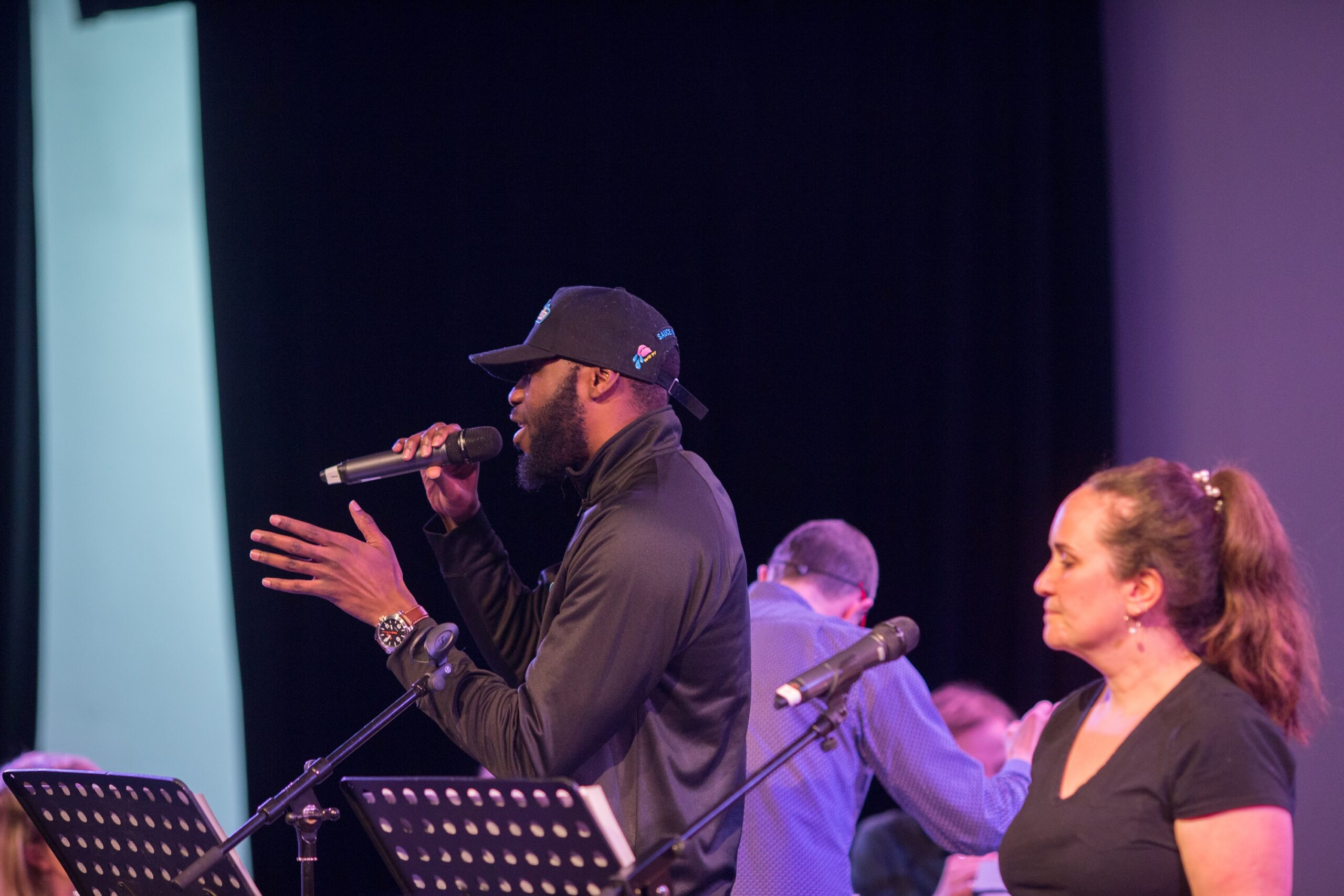 Singers with microphones on a stage