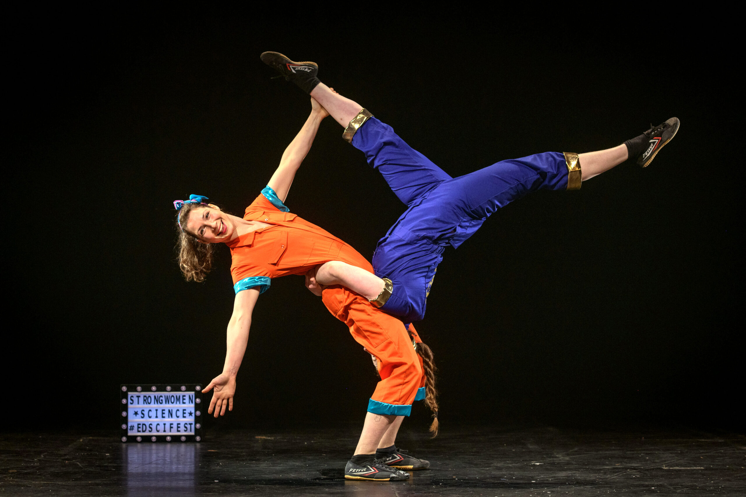 Two circus performers on stage at the Strong Women Science show.