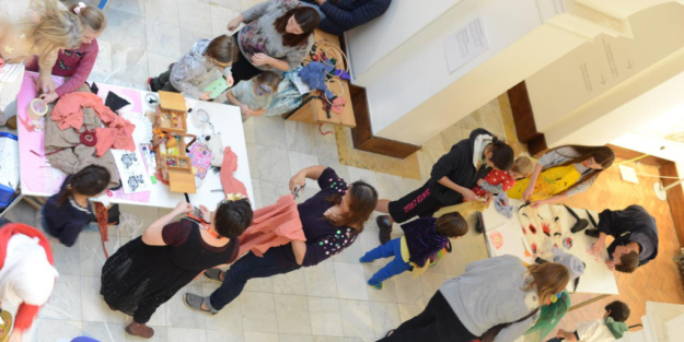 Aerial view of families crafting with various fabrics