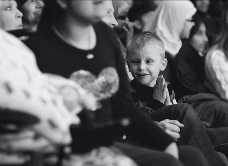 Black and white photo of a family audience